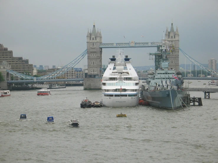 a boat sits in the water near a bridge