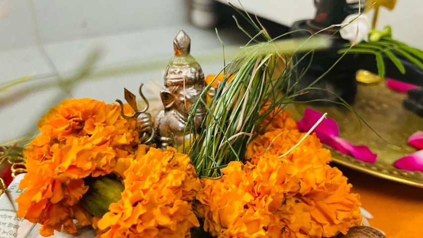 flowers, nches and a figurine on a table