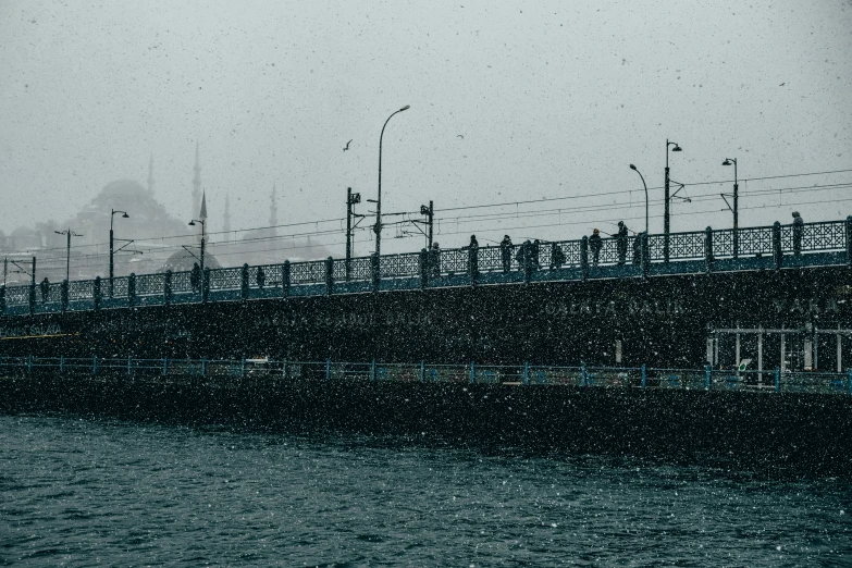 a bridge and people walking in the rain