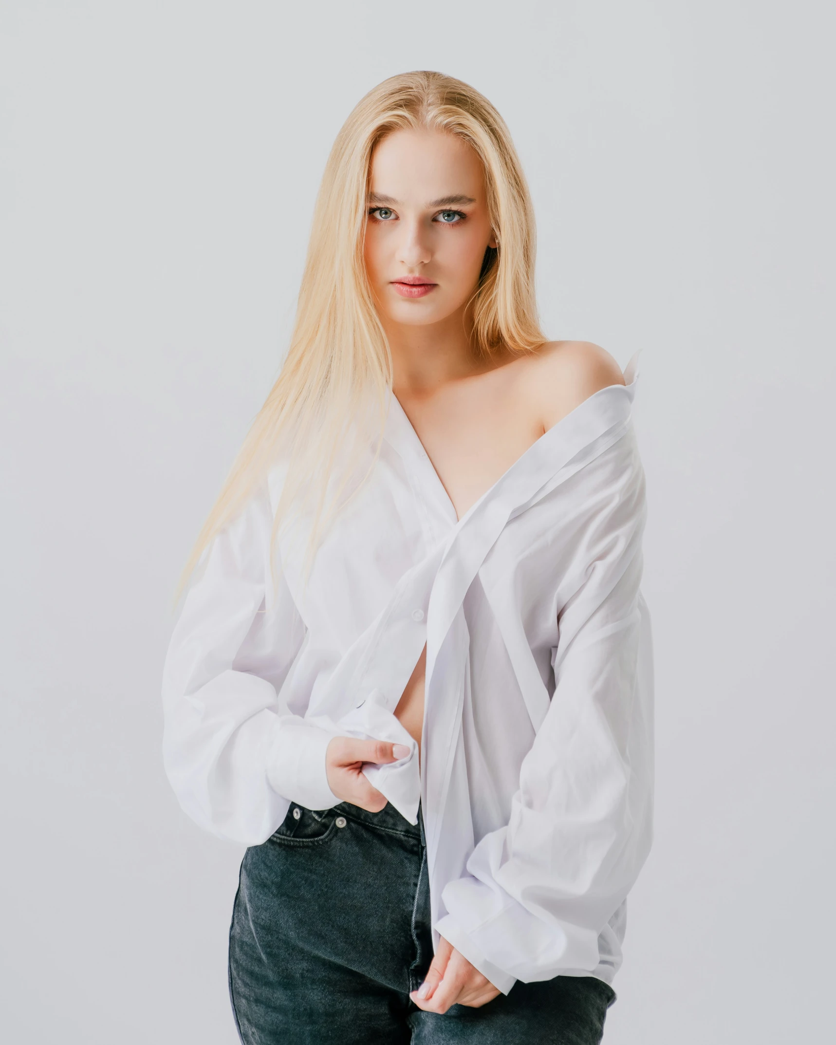 a woman in white blouse posing for a po