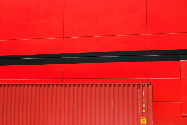 a red building with black lines and a black stripe