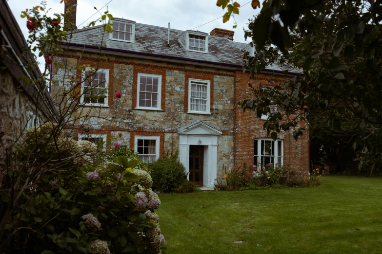 a brick house with a white door and windows