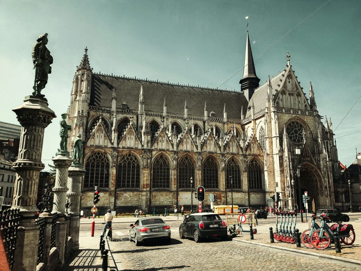 a car and bicycles are parked in front of the large building