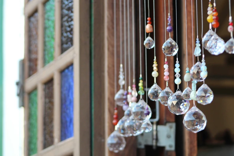 the beads are hanging outside of a window