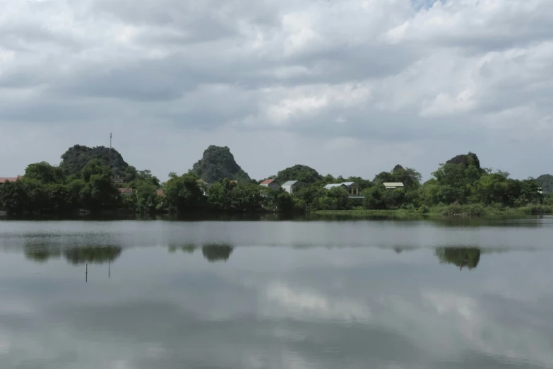 water with a bunch of trees and clouds on it