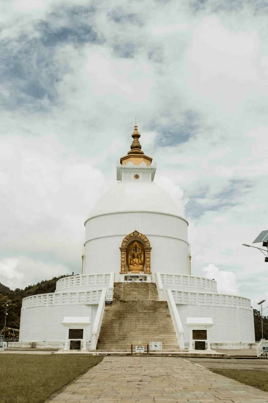 the large white building with a golden statue on top