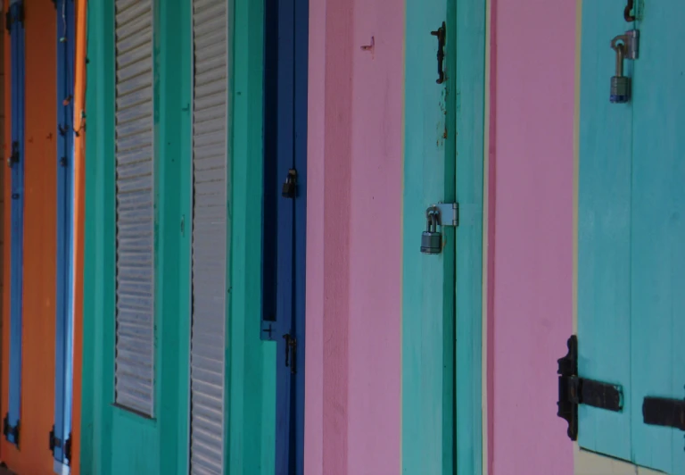 there is some pink and green doors on the wall