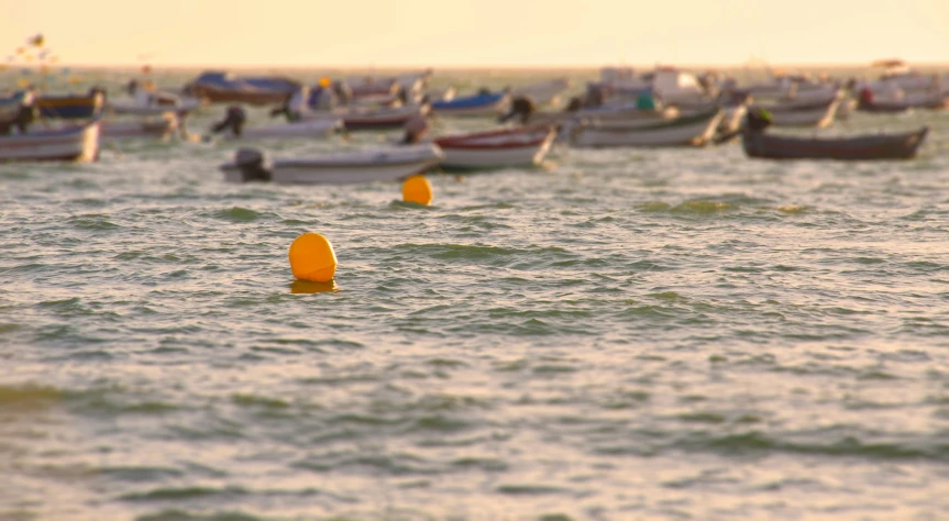 several rows of small boats in the ocean