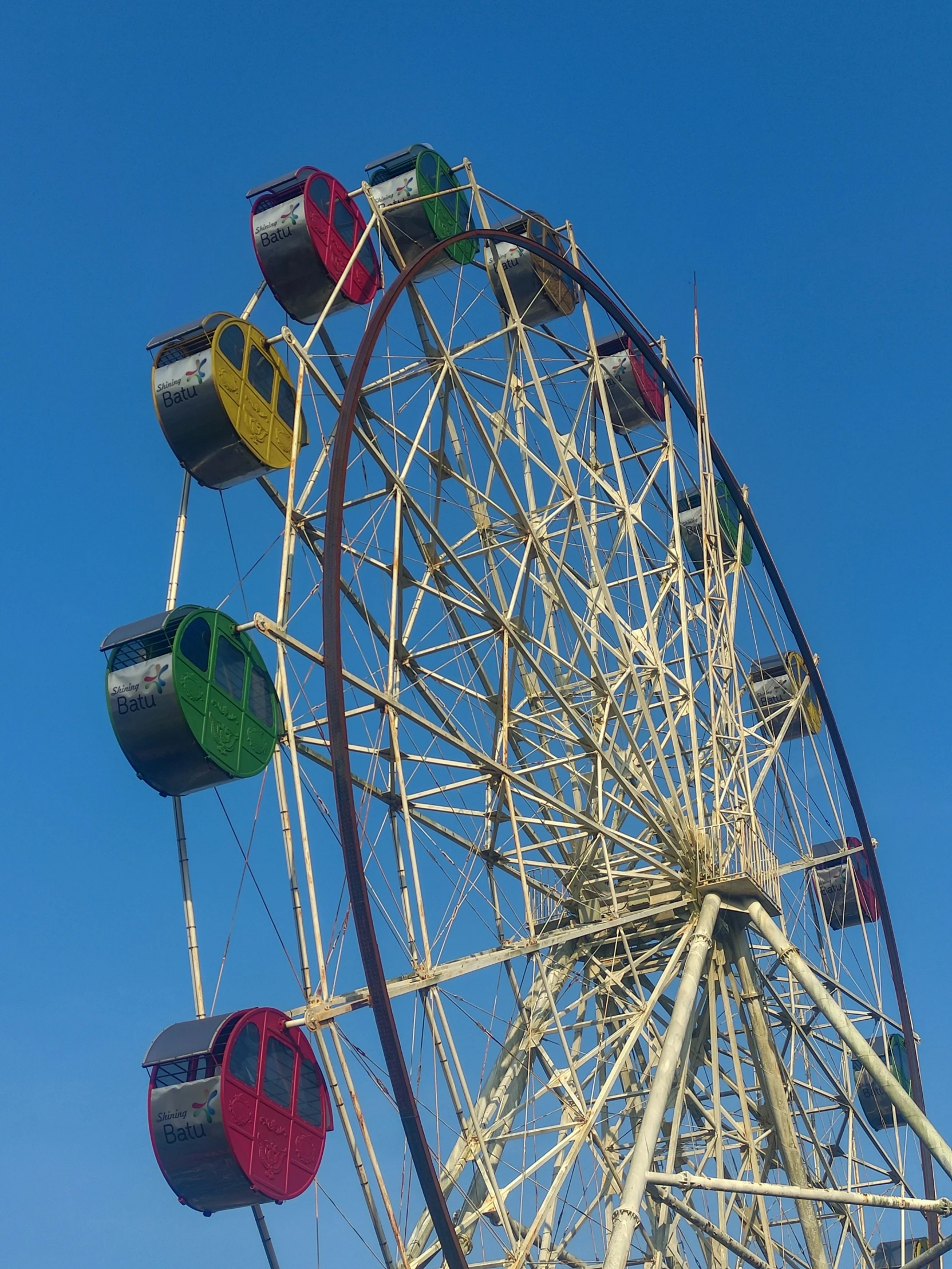 a ferris wheel sitting under a clear blue sky