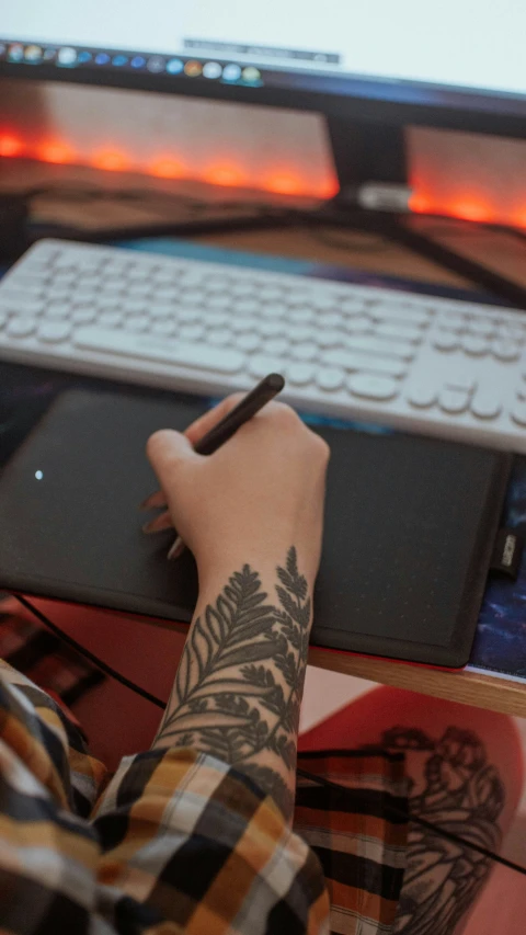 a man is writing on his laptop computer