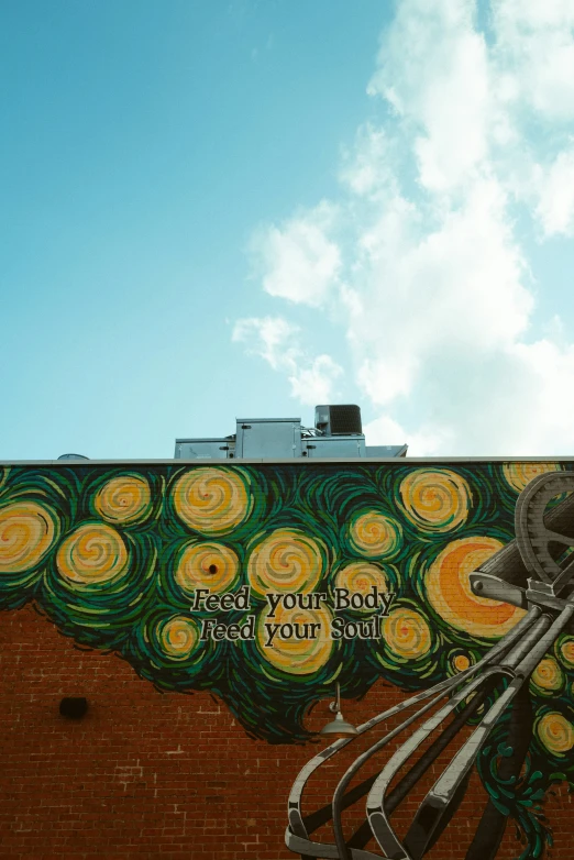 a brick building with a large colorful mural on the side