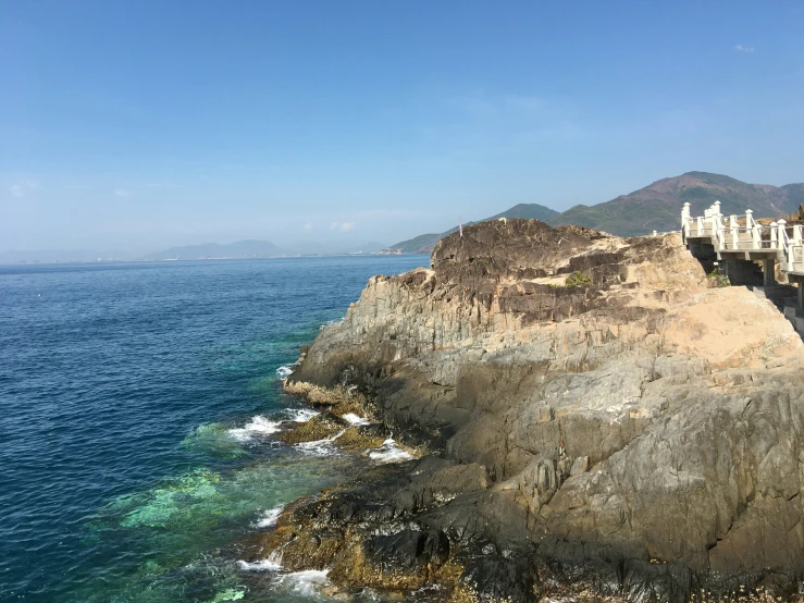 houses perched on a cliff above the ocean