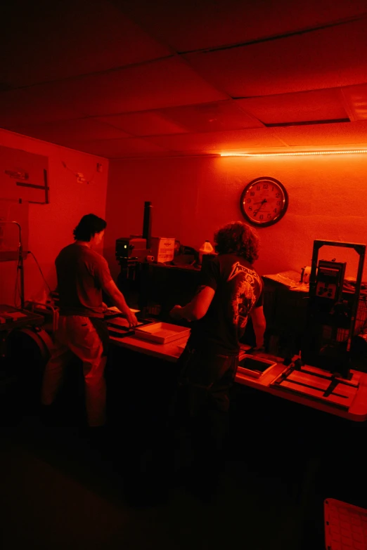 a woman is making soing out of wood in the dark