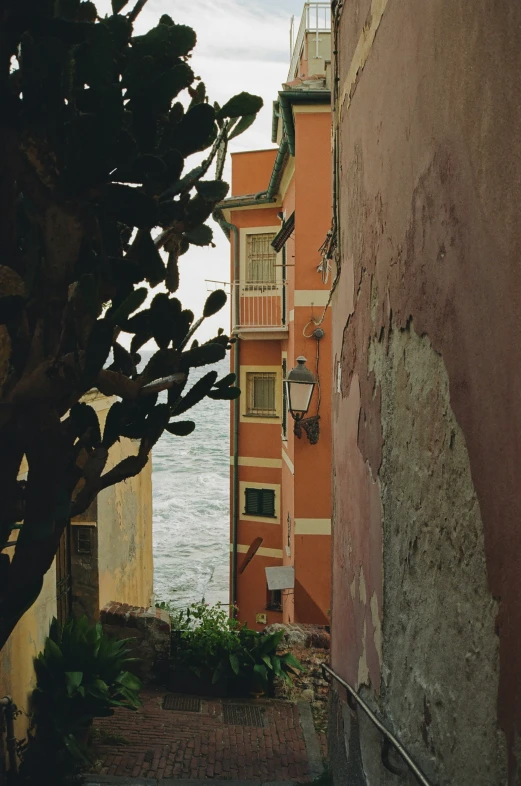 a street scene looking down at an old building by the ocean