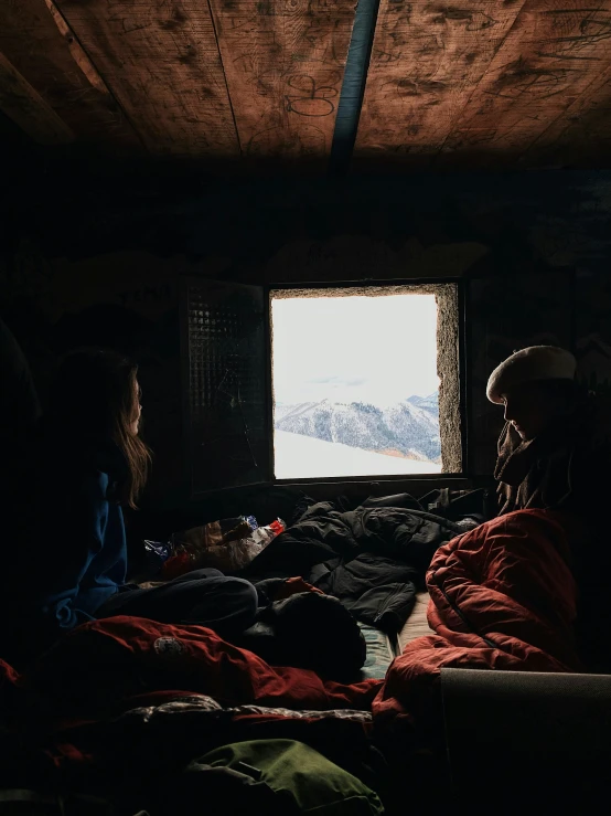 people in a dimly lit room with mountains