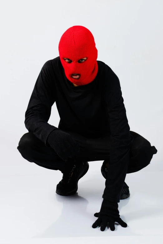 a person with red face and black body in crouch