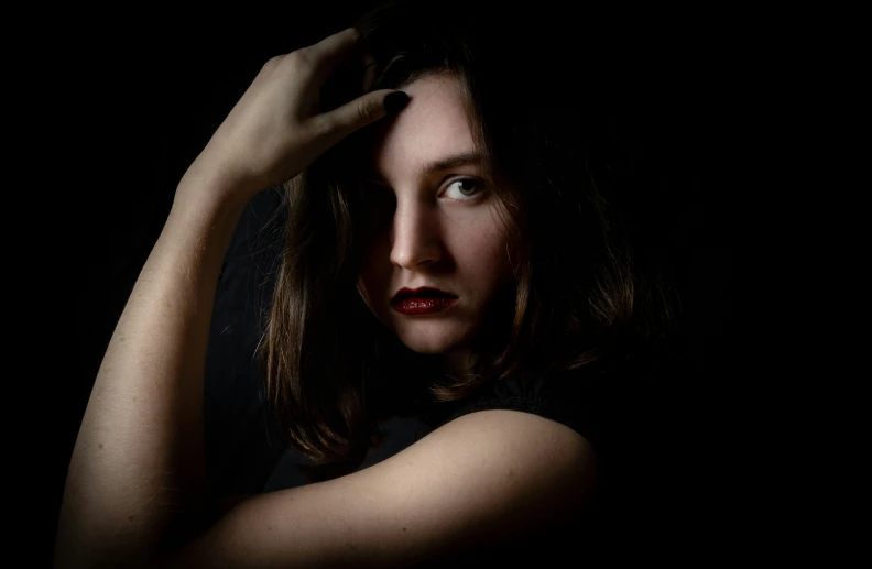 a woman holding her head as if she's having trouble of hair