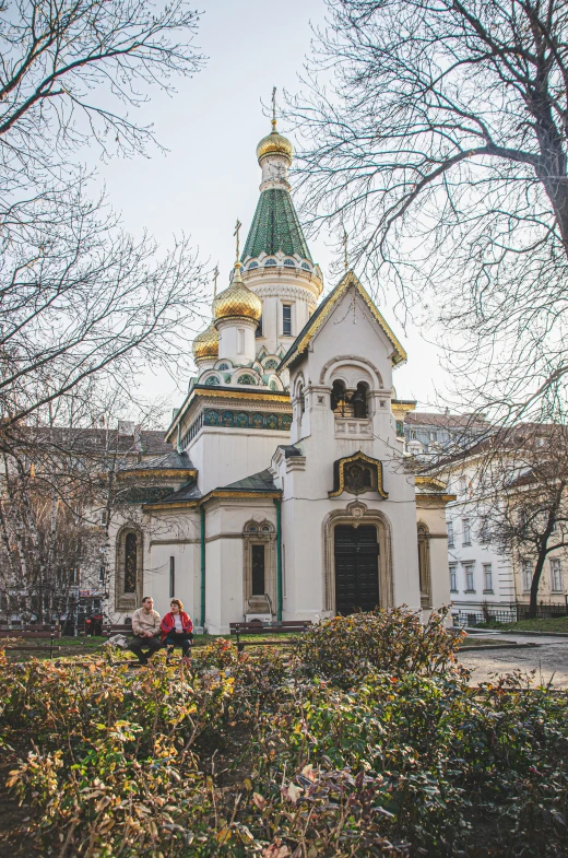 a small church is in a park with trees