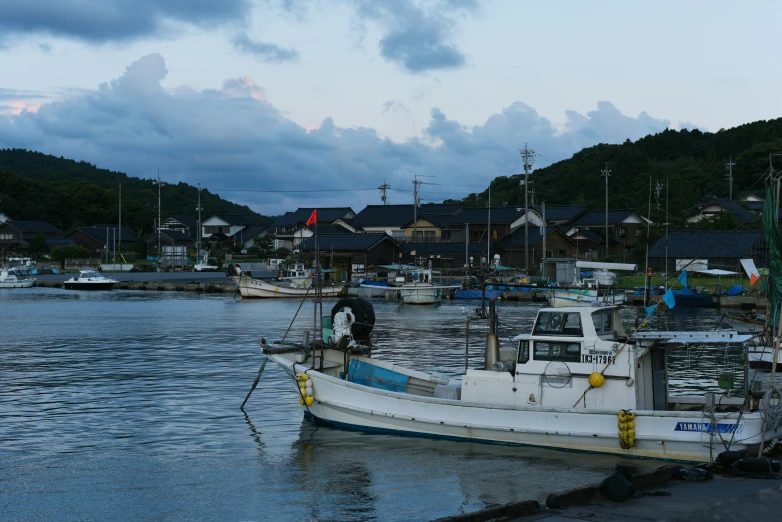 a boat is sitting at the dock next to the water