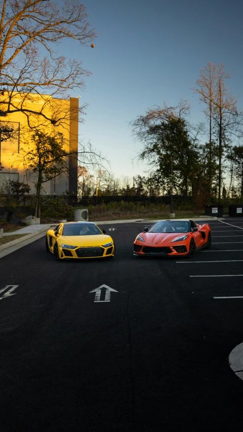 two supercar parked in a parking lot next to trees