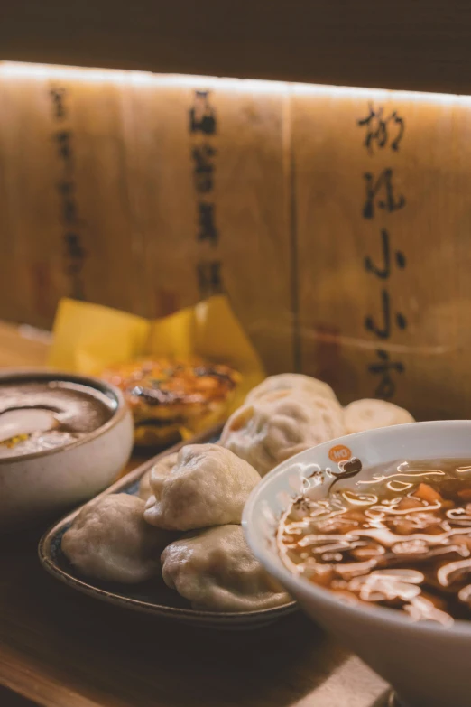 bowl of soup, bread and soup plates in front of sack of rice paper