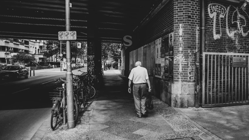 a man is walking down the sidewalk alone