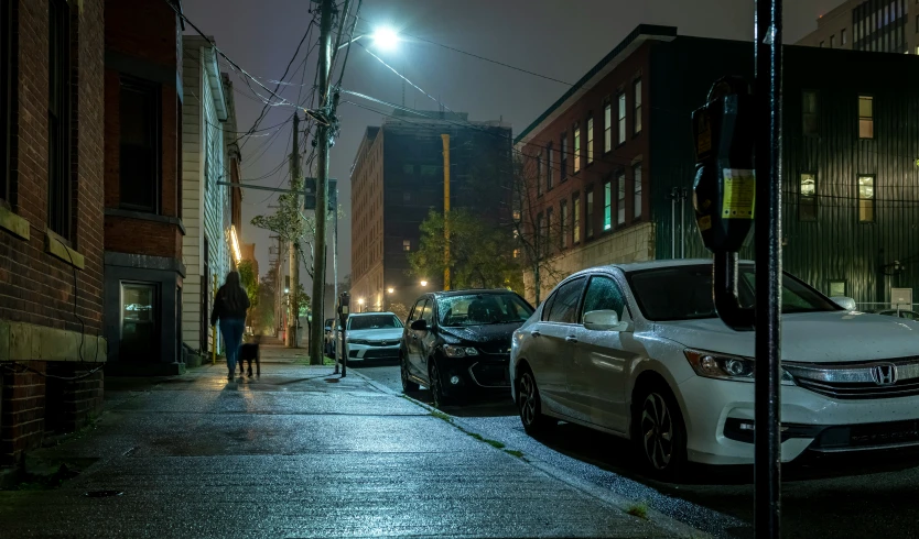 two cars parked on the side of a city street