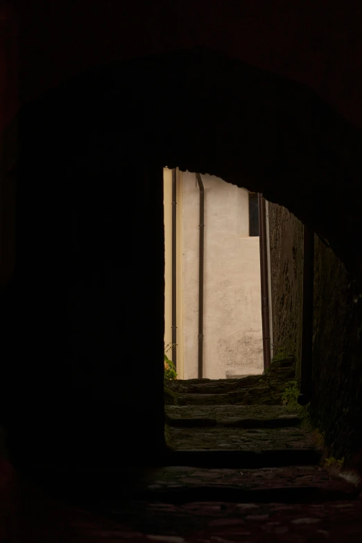 an archway with light coming in at night