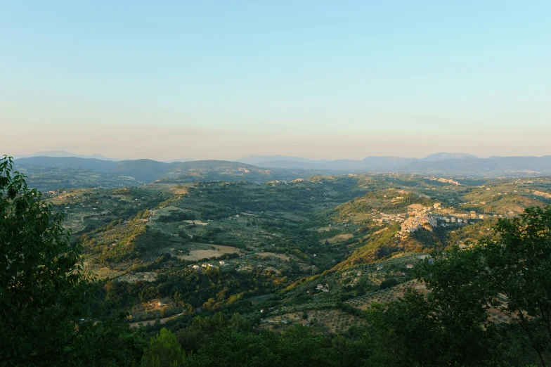 view over wooded area to mountains on a sunny day