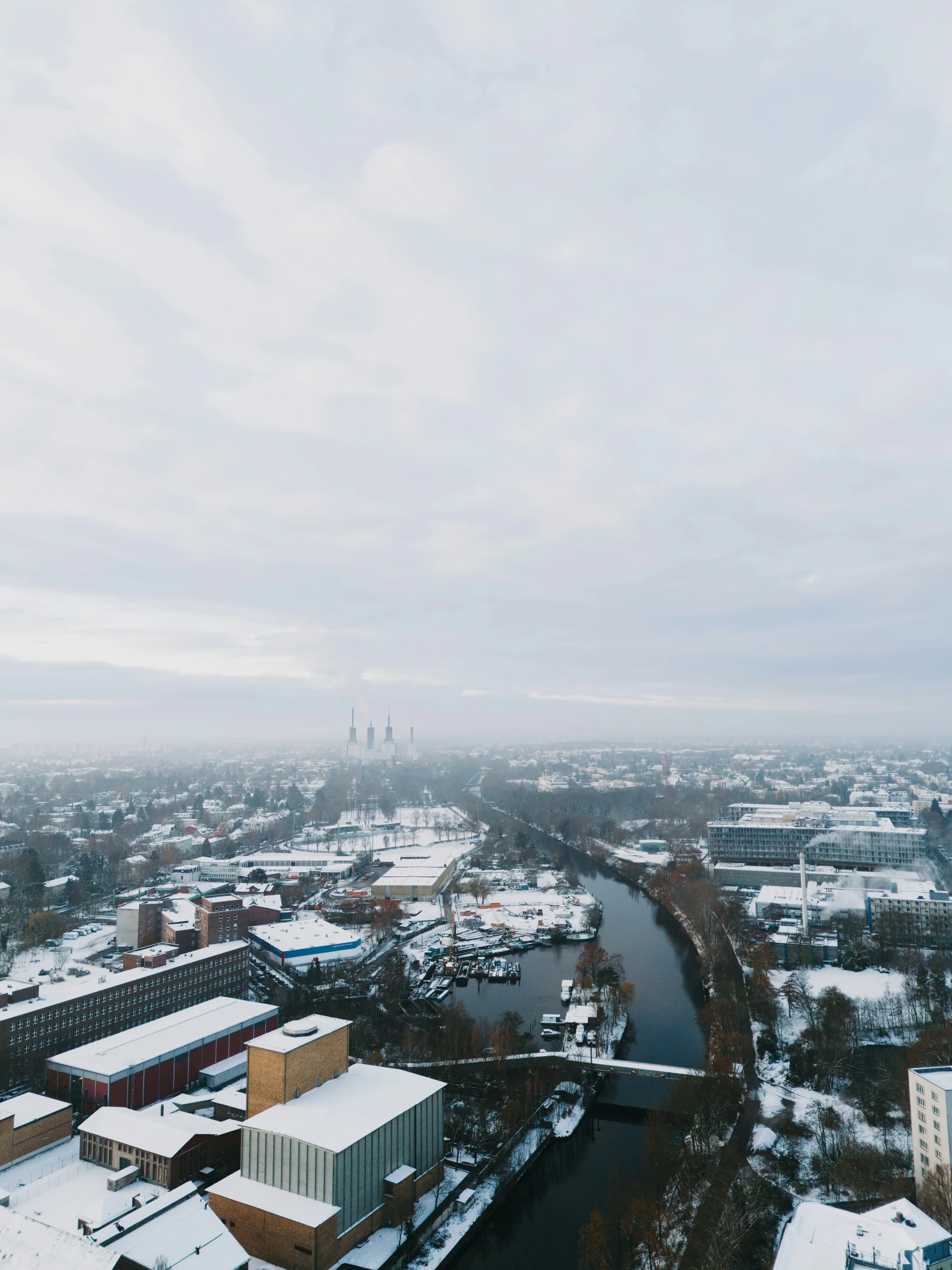 a river flowing through a snow covered city