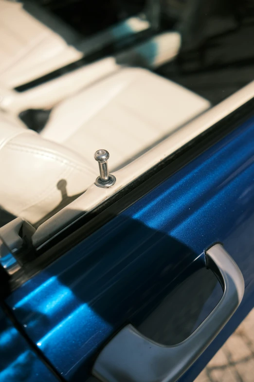 a close up view of the door handle and handle on a blue car