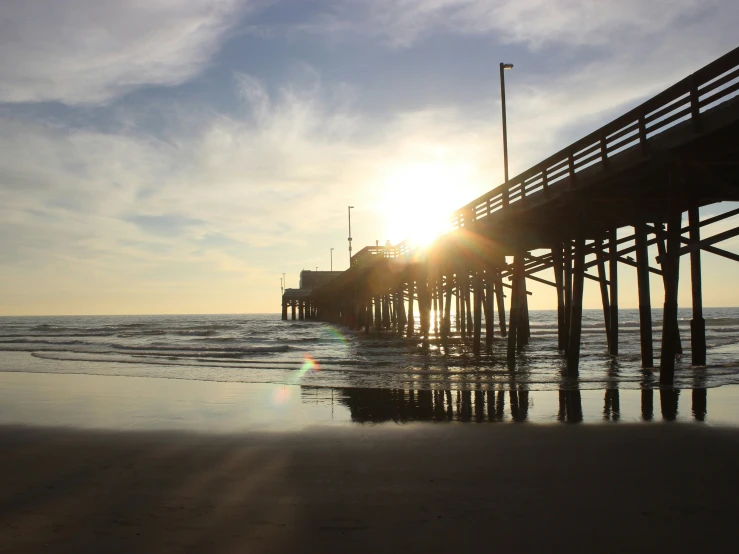 a very big pretty beach pier on a sunny day