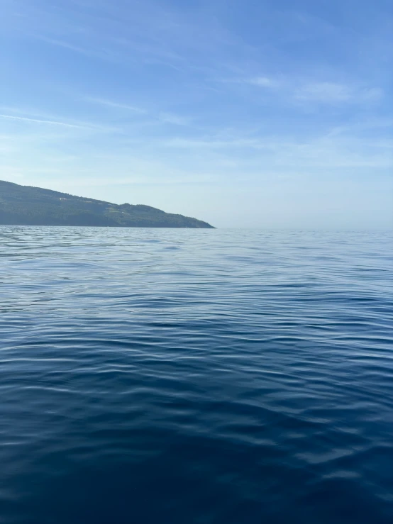 a view of the water, from a boat on a bright sunny day