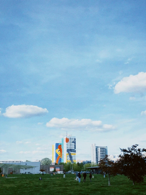 an airplane flying in the sky near a big building