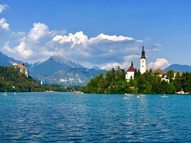 an island with a church on it is in the middle of the water