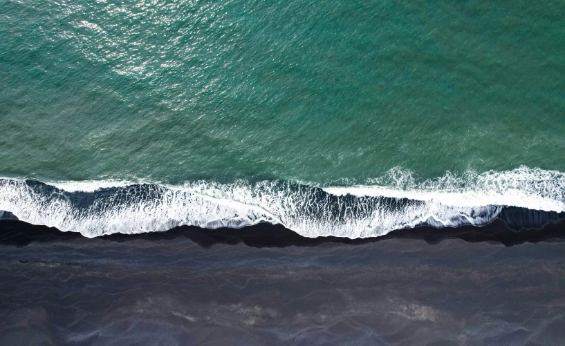 a small boat in the ocean near a beach