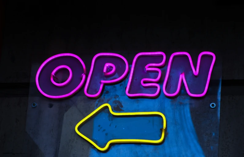 a neon sign that says open and pointing right with an arrow