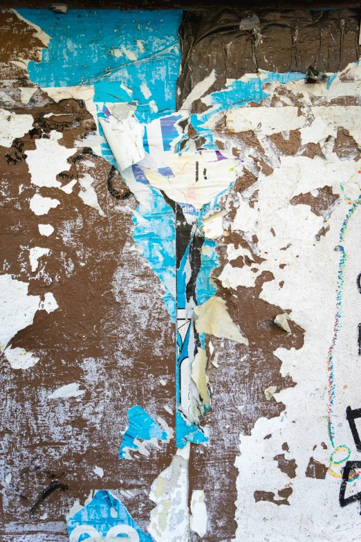 blue and white pieces of paper attached to a wooden pole