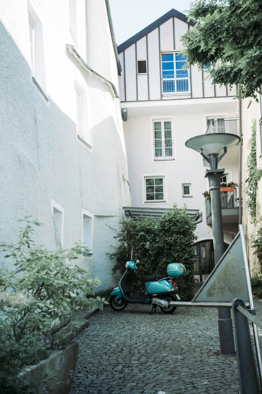 motor scooters parked next to a tall white building