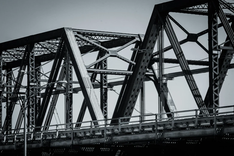 a black and white po of a bridge with a man walking across the bridge