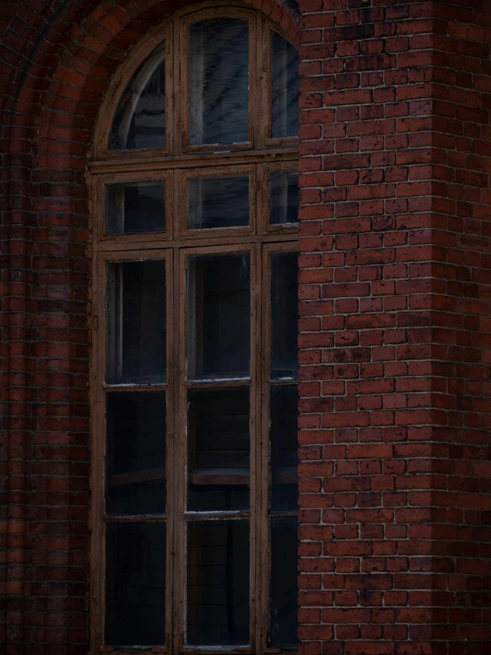 a picture of an old window on a brick wall