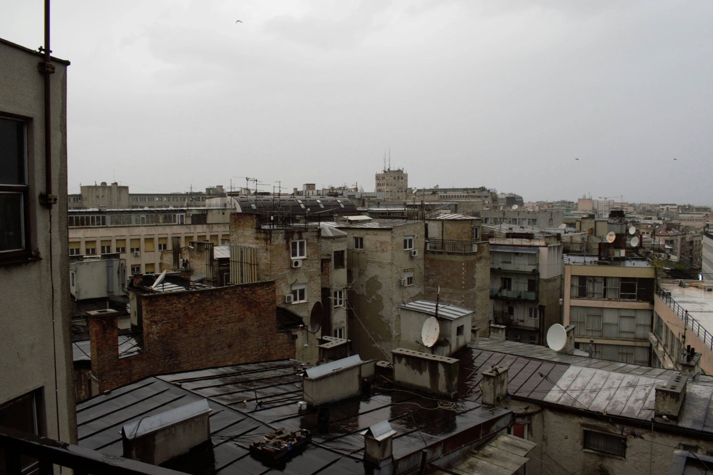 buildings with roofs and windows under gray skies