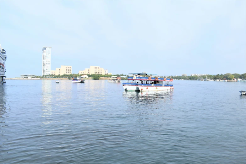 a large boat traveling on a body of water near buildings