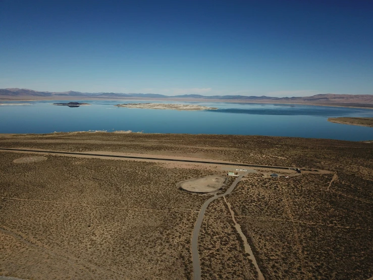 the view of water from an airplane over some hills