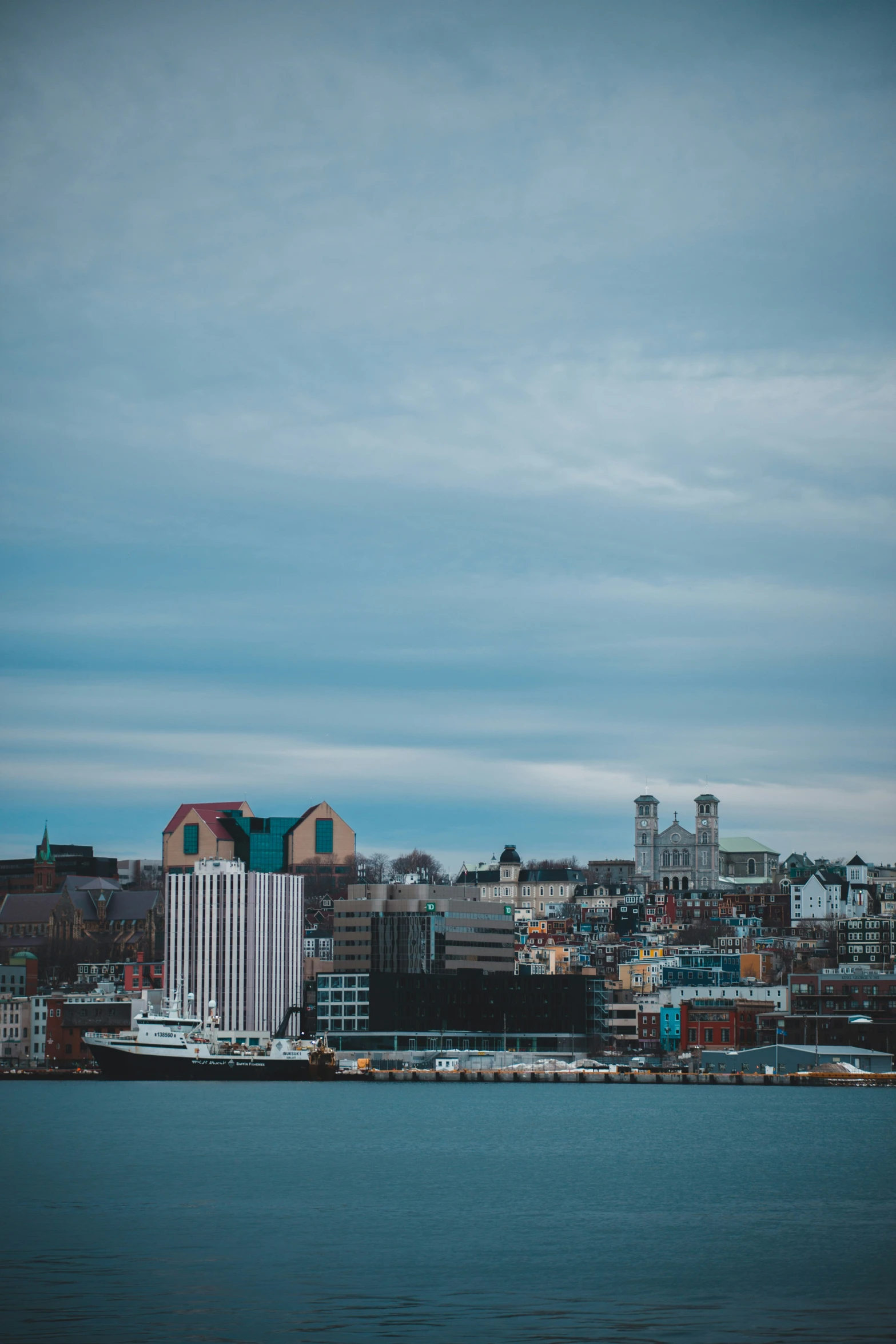 a large body of water with a city in the background