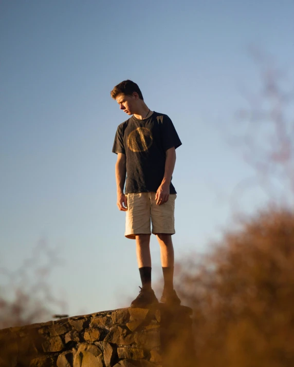 a person is standing on top of a rock