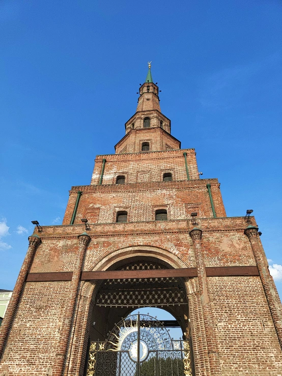 a large brick clock tower with people on it