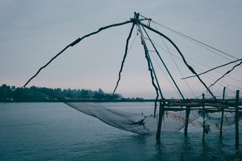 a fishing net in the water with lots of ropes