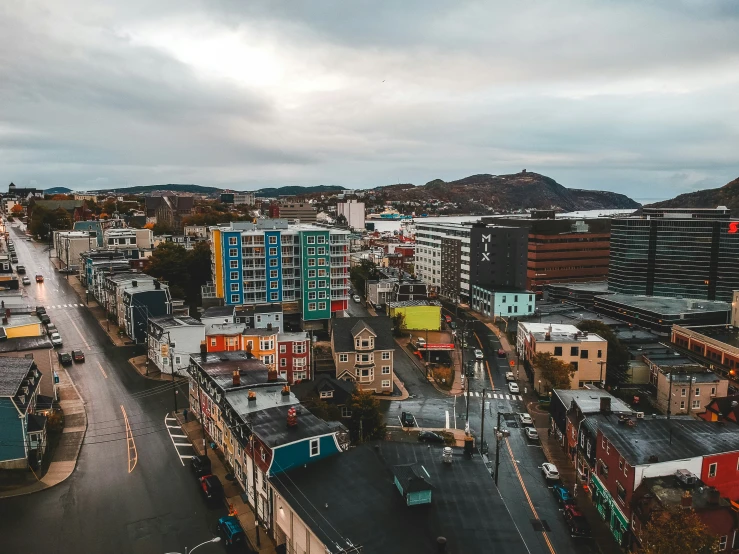 a very high angle view of some buildings and the road