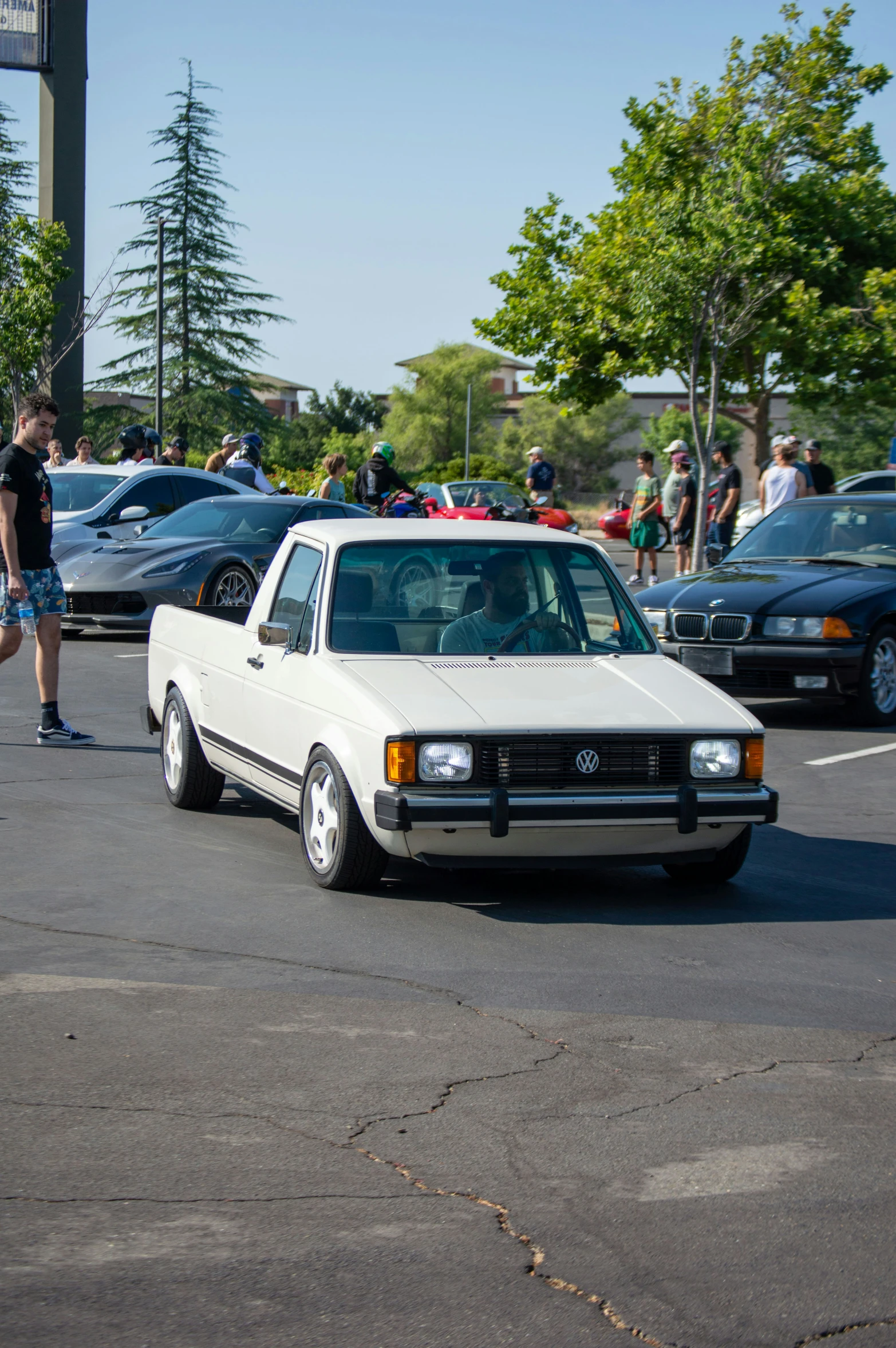 people and vehicles stopped in a parking lot